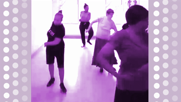 Image from Aurora Reyes dance class. Image is black white, tinted magenta purple. Border on each side is magenta purple background with polka dot overlay in three columns. Four participants, Center upstage Latina woman, dark hair in a bun, dancing in t-shirt and billowy exercise pants, no shoes due to foot injury; Right mid-stage, white short-haired Jewish senior woman dancing in light t-shirt and A-line skirt with flamenco shoes, Left downstage, light-haired Latina woman dancing in black t-shirt and bicycle style shorts and flamenco shoes, hair in bun, Left downstage African American woman dancing facing left, dark hair in loose bun, light short sleeve shirt, black flamenco skirt, body cropped out of image at thigh.